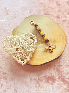 Black and yellow beaded charm with bee