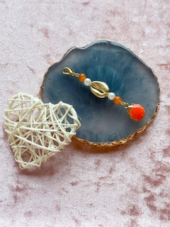 Orange beaded charm with shell